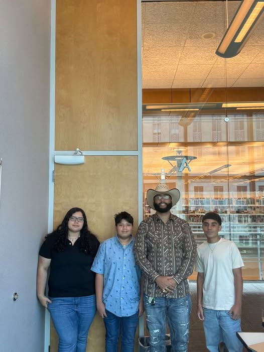 Community Compass NxtGen founder Dimitri Rice with youth and community members